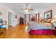 Bright main bedroom with hardwood floors, ceiling fan, and ensuite bathroom at 1106 Aycock Ave, Burlington, NC 27215