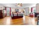 Spacious main bedroom suite with hardwood floors, ceiling fan, and ensuite bathroom at 1106 Aycock Ave, Burlington, NC 27215