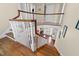 View from the top of the staircase looking down to the entry and living spaces at 1106 Aycock Ave, Burlington, NC 27215