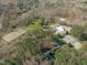 Aerial view of community pool, horse training area and tennis courts surrounded by lush trees at 11808 Black Horse Run, Raleigh, NC 27613
