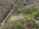 Aerial view featuring horse training area with lush trees and well-maintained greenery at 11808 Black Horse Run, Raleigh, NC 27613