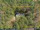 Aerial view of the property showing the home and surrounding lush green trees at 11808 Black Horse Run, Raleigh, NC 27613