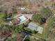 Aerial view showcasing community pool, tennis courts and parking surrounded by lush trees at 11808 Black Horse Run, Raleigh, NC 27613