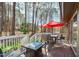 Relax on the back deck with a fire pit, outdoor seating, and wooded views at 11808 Black Horse Run, Raleigh, NC 27613