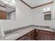 Bathroom featuring double sinks, granite countertops, and wood cabinets at 11808 Black Horse Run, Raleigh, NC 27613