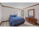Cozy bedroom featuring a bed, dresser, and bedside lamp, offering a relaxing retreat at 11808 Black Horse Run, Raleigh, NC 27613
