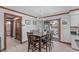 Traditional dining room with wood table, seating for six, wood floors, and sliding door to back deck at 11808 Black Horse Run, Raleigh, NC 27613