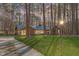Charming single-story brick home with well-manicured lawn and mature trees, exuding curb appeal and natural beauty at 11808 Black Horse Run, Raleigh, NC 27613