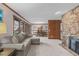 Cozy living room featuring a stone fireplace, comfortable seating, and large windows at 11808 Black Horse Run, Raleigh, NC 27613