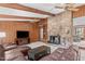 Comfortable living room featuring a stone fireplace, wood details, and comfortable leather seating at 11808 Black Horse Run, Raleigh, NC 27613