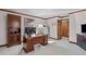 Functional office space featuring a wooden desk, storage cabinets, and office equipment at 11808 Black Horse Run, Raleigh, NC 27613