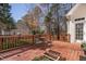 Inviting back deck with wood railing and furniture, overlooking a well-maintained lawn at 1217 Wedgeland Dr, Raleigh, NC 27615