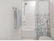 Bright bathroom featuring a shower-tub combo with a clean, floral patterned shower curtain and neutral tile at 1217 Wedgeland Dr, Raleigh, NC 27615