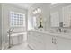 Beautiful bathroom with a standalone tub, double vanity sinks and a glass block window at 1217 Wedgeland Dr, Raleigh, NC 27615