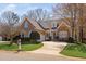 Charming brick home featuring blue shutters, a well-manicured lawn, and an extended driveway at 1217 Wedgeland Dr, Raleigh, NC 27615