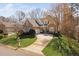 Charming brick home featuring a well-manicured lawn, curved driveway, and inviting front porch at 1217 Wedgeland Dr, Raleigh, NC 27615
