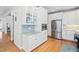 Bright kitchen features white cabinetry, stainless steel appliances, and wood flooring at 1217 Wedgeland Dr, Raleigh, NC 27615