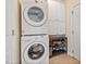 Functional laundry area includes stacked washer/dryer and storage cabinets at 1217 Wedgeland Dr, Raleigh, NC 27615