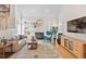 Bright living room featuring a fireplace, hardwood floors, and an entertainment center at 1217 Wedgeland Dr, Raleigh, NC 27615