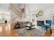 Cozy living room with a fireplace, neutral-toned sofa, area rug, and staircase at 1217 Wedgeland Dr, Raleigh, NC 27615