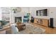 Spacious living room with fireplace, hardwood floors, and a television at 1217 Wedgeland Dr, Raleigh, NC 27615
