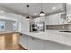 Bright, modern kitchen boasts white cabinets, stainless steel appliances, and a large island at 1222 Coach Station Alley # 101, Raleigh, NC 27601