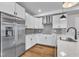 Modern kitchen showcases stainless steel appliances, sleek white cabinets, and a stylish backsplash at 1222 Coach Station Alley # 101, Raleigh, NC 27601