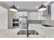 Stylish kitchen featuring quartz countertops and stainless steel appliances at 1222 Coach Station Alley # 101, Raleigh, NC 27601