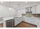 Bright kitchen featuring white cabinetry, quartz countertops, and stainless steel appliances at 1226 Coach Station Alley # 101, Raleigh, NC 27601
