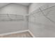 Spacious walk-in closet featuring wire shelving units against a neutral wall, perfect for organized storage at 1226 Coach Station Alley # 101, Raleigh, NC 27601