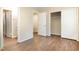 Well-lit bedroom with hardwood floors, closet, and adjacent bathroom with simple and functional design at 1245 Schaub Dr, Raleigh, NC 27606