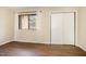 Bedroom featuring hardwood floors, a window with curtains, and a double door closet at 1245 Schaub Dr, Raleigh, NC 27606