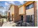 Brick and wood exterior of townhomes with small, fenced front patios and well kept landscaping at 1245 Schaub Dr, Raleigh, NC 27606
