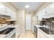 Efficient kitchen with white appliances and cabinets, offering ample counter space and a light-filled atmosphere at 1245 Schaub Dr, Raleigh, NC 27606