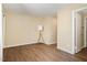 Bright living room boasts hardwood floors, neutral walls, and a contemporary floor lamp at 1245 Schaub Dr, Raleigh, NC 27606