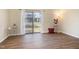 Bright living room with hardwood flooring and sliding glass doors leading to a private backyard at 1245 Schaub Dr, Raleigh, NC 27606