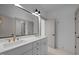 Dual vanity bathroom with a large mirror and modern fixtures at 1318 Ivy Ln, Raleigh, NC 27609