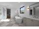 Bathroom showcasing a standalone tub, dual vanities, and natural lighting at 1318 Ivy Ln, Raleigh, NC 27609
