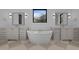 Bathroom featuring a standalone tub, dual vanities, and modern fixtures at 1318 Ivy Ln, Raleigh, NC 27609