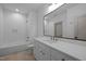 Bathroom features a white vanity with gold hardware, and white subway tile shower at 1318 Ivy Ln, Raleigh, NC 27609
