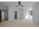 Open bedroom featuring neutral carpet, modern fan, and natural light from a window at 1318 Ivy Ln, Raleigh, NC 27609