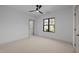 Bright bedroom features a modern ceiling fan and a window with black trim at 1318 Ivy Ln, Raleigh, NC 27609