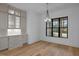 Bright dining area with hardwood floors, a modern chandelier, and built-in cabinets at 1318 Ivy Ln, Raleigh, NC 27609