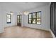 Inviting dining space with natural light, hardwood floors, and modern chandeliers, ideal for Gathering gatherings at 1318 Ivy Ln, Raleigh, NC 27609
