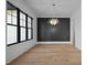 Bright dining area features hardwood floors, a modern chandelier, and a large window, perfect for entertaining at 1318 Ivy Ln, Raleigh, NC 27609