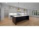 Open kitchen layout with a large island, white countertops, and stylish pendant lighting, ideal for hosting at 1318 Ivy Ln, Raleigh, NC 27609