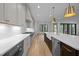 Gourmet kitchen with an island, farmhouse sink, and stainless steel appliances, great for culinary enthusiasts at 1318 Ivy Ln, Raleigh, NC 27609