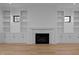 Bright living room featuring a fireplace and symmetrical built-in shelving at 1318 Ivy Ln, Raleigh, NC 27609