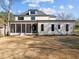 A modern home featuring a screened porch and a well-maintained lawn in a residential setting at 1318 Ivy Ln, Raleigh, NC 27609