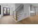 Staircase featuring wood treads, black metal railings, and natural light at 1318 Ivy Ln, Raleigh, NC 27609